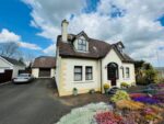 Detached chalet 1 Stoney Lane - cream exterior with front porch and mature front garden